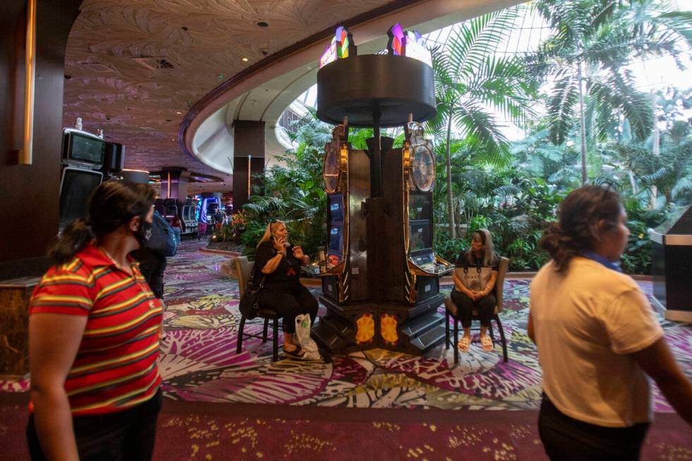 Tourists sit at old slot machines in The Mirage, Wednesday, July 10, 2024, in Las Vegas. (Danie ...