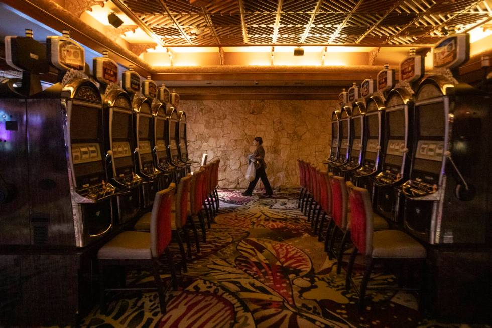 A custodian cleans old slot machines at The Mirage, Wednesday, July 10, 2024, in Las Vegas. (Da ...