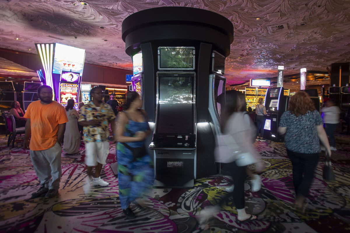 Tourists walk by old slot machines at The Mirage, Wednesday, July 10, 2024, in Las Vegas. (Dani ...