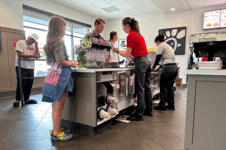 Workers serve customers at a fast food restaurant Thursday, June 27, 2024, in southeast Denver. ...