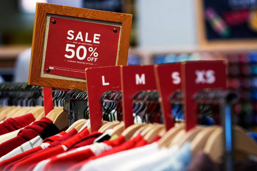 A sale sign is displayed on a rack of clothes at a store in Chicago, Monday, June 10, 2024. On ...