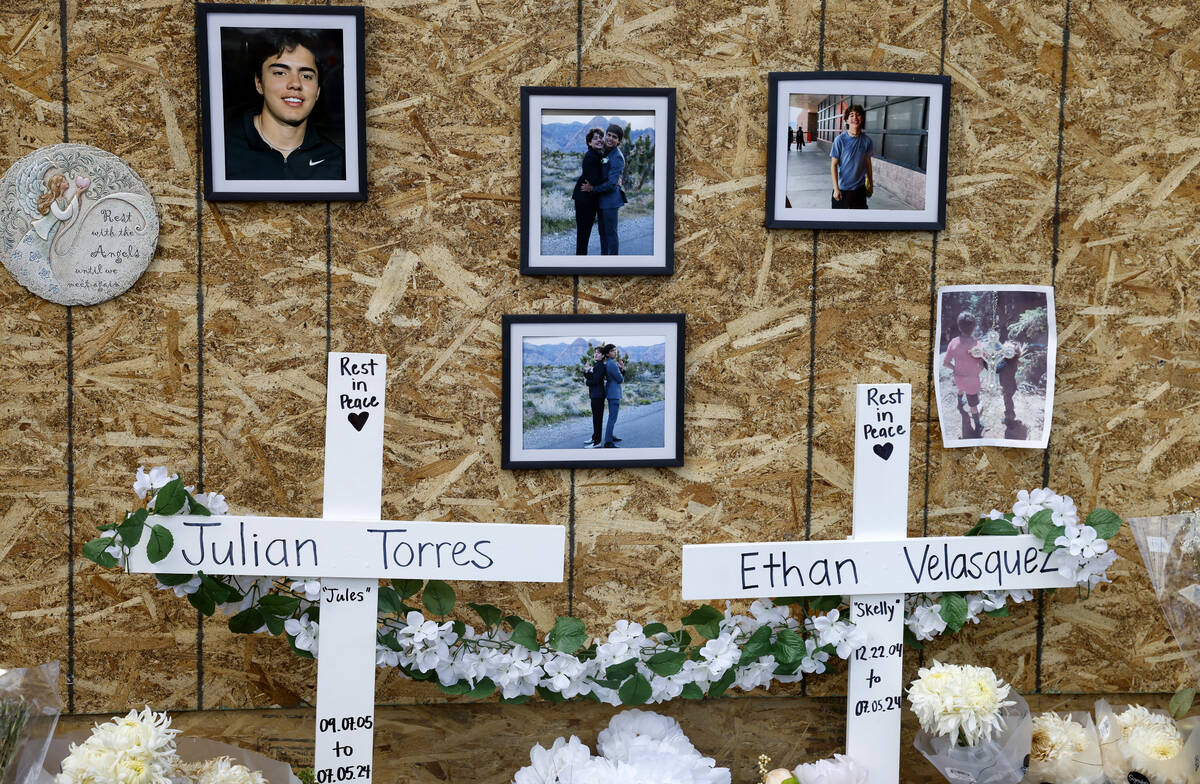 Photographs of Julian Torres, left, and Ethan Velasquez, are displayed at a makeshift memorial ...