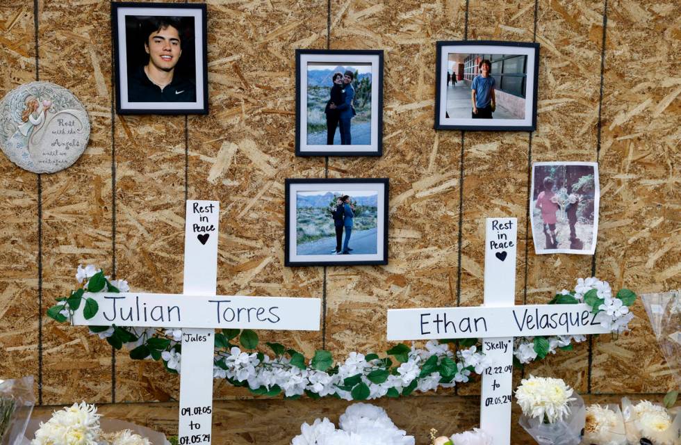 Photographs of Julian Torres, left, and Ethan Velasquez, are displayed at a makeshift memorial ...