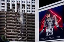 An old ad for MJ Live remains on the marquis as debris is pushed out of a higher floor of the t ...