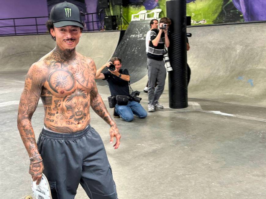 Nyjah Huston smiles as he walks past photographers at his private skate park in San Clemente, C ...