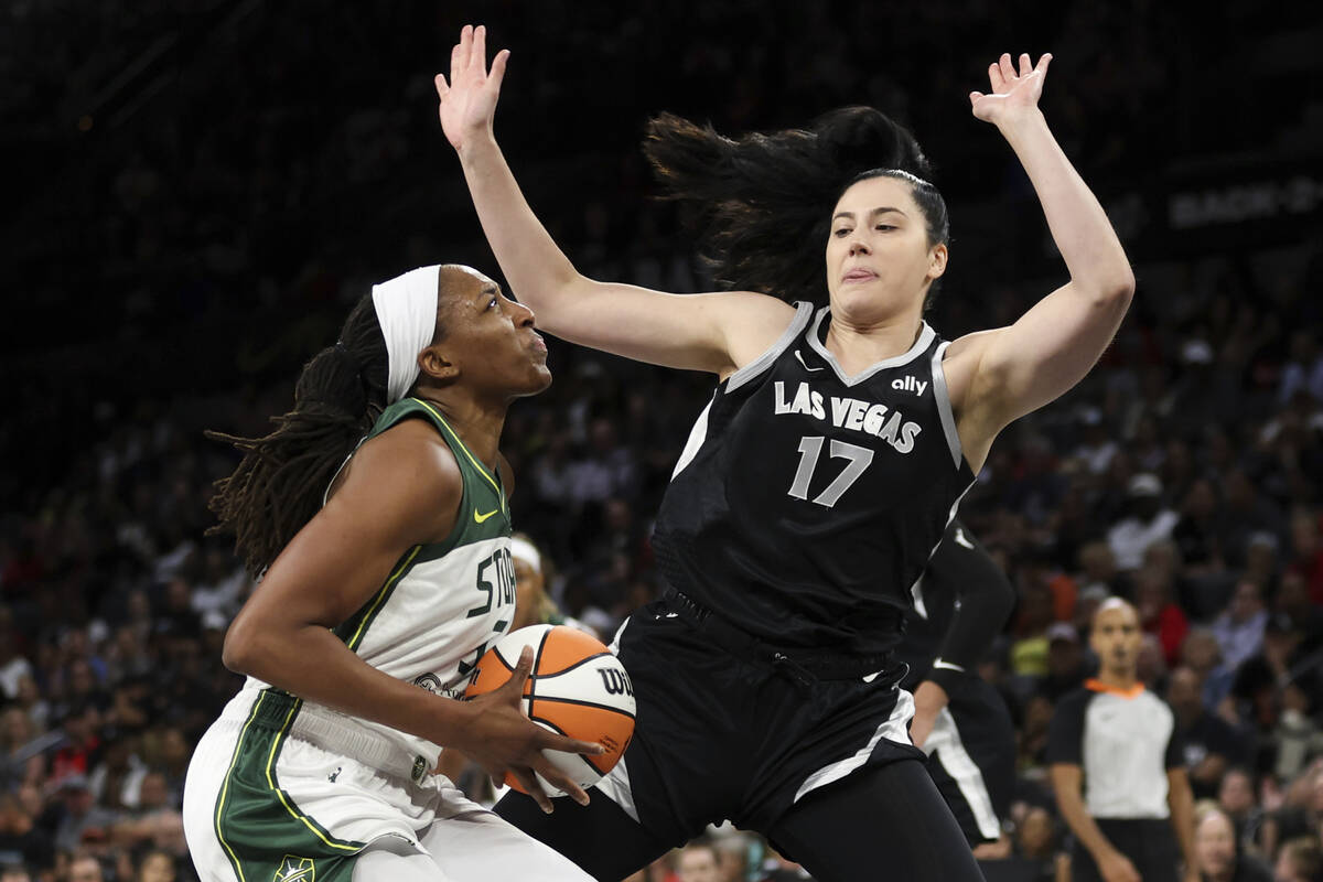 Seattle Storm forward Nneka Ogwumike, left, is defended by Las Vegas Aces center Megan Gustafso ...