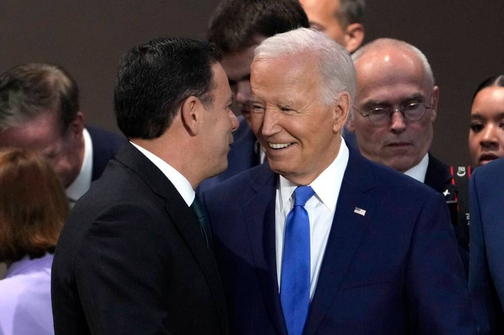 Portuguese Prime Minister Luis Montenegro, left, speaks with President Joe Biden at Working Ses ...