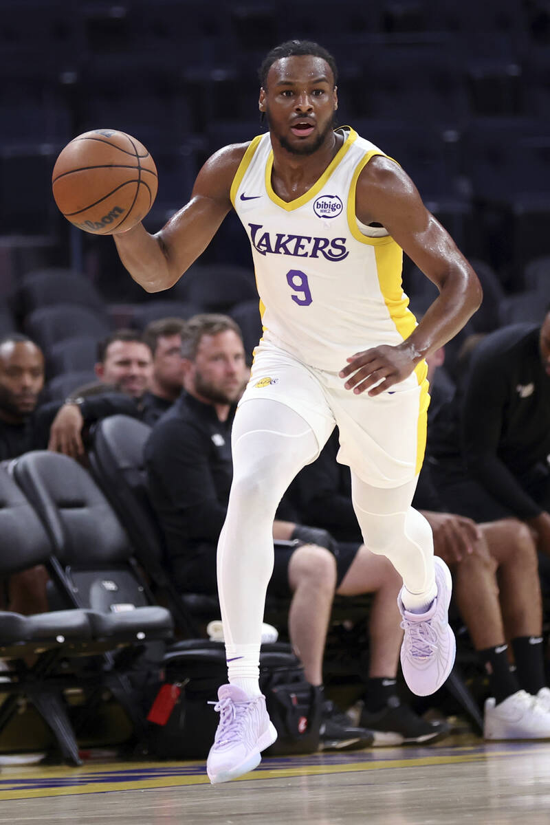Los Angeles Lakers' Bronny James moves the ball against the Miami Heat during an NBA summer lea ...