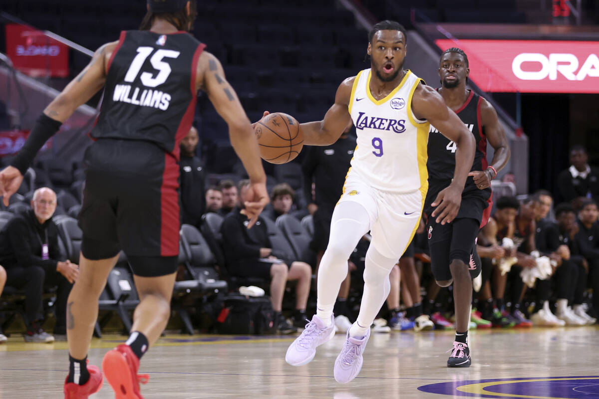 Los Angeles Lakers' Bronny James (9) looks to pass against the Miami Heat during an NBA summer ...