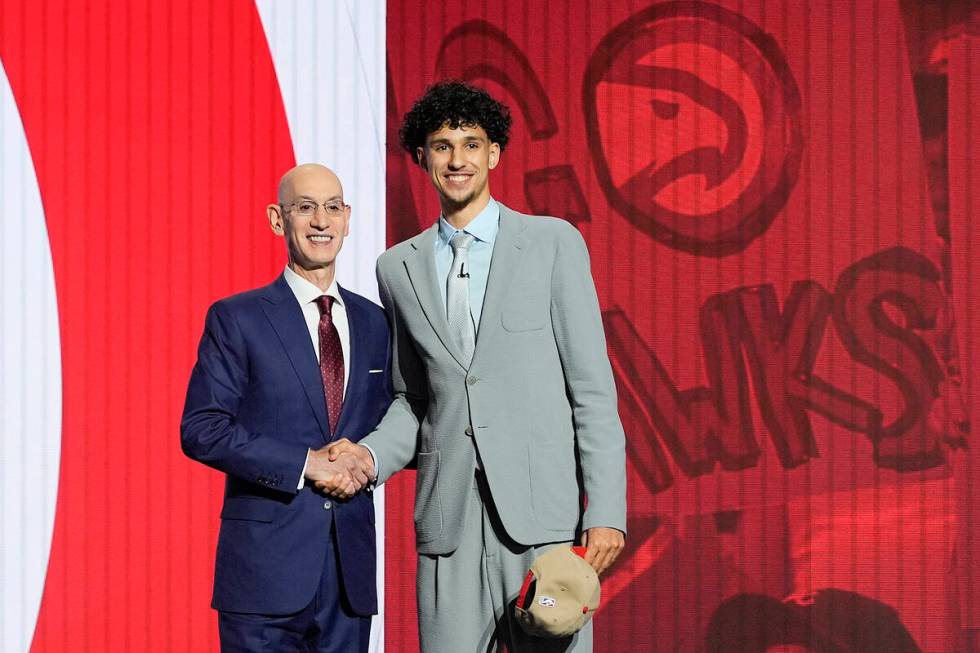 Zaccharie Risacher, right, poses for a photo with NBA commissioner Adam Silver after being sele ...