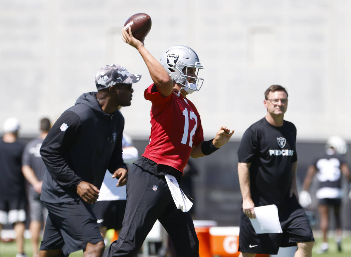 Raiders quarterback Aidan O'Connell (12) throws the ball during an NFL football practice at the ...
