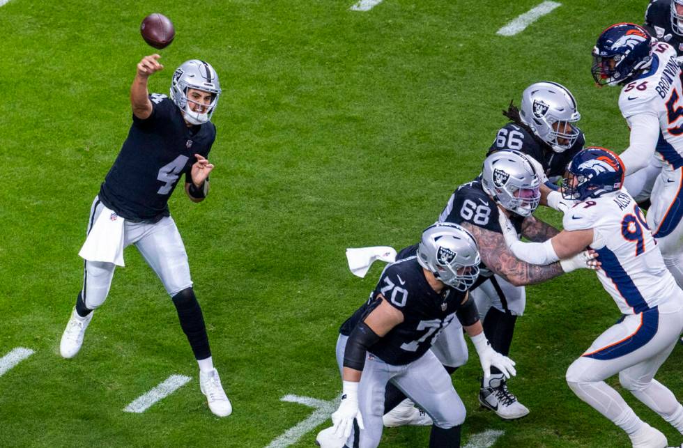 Raiders quarterback Aidan O'Connell (4) gets off a pass against the Denver Broncos during the f ...