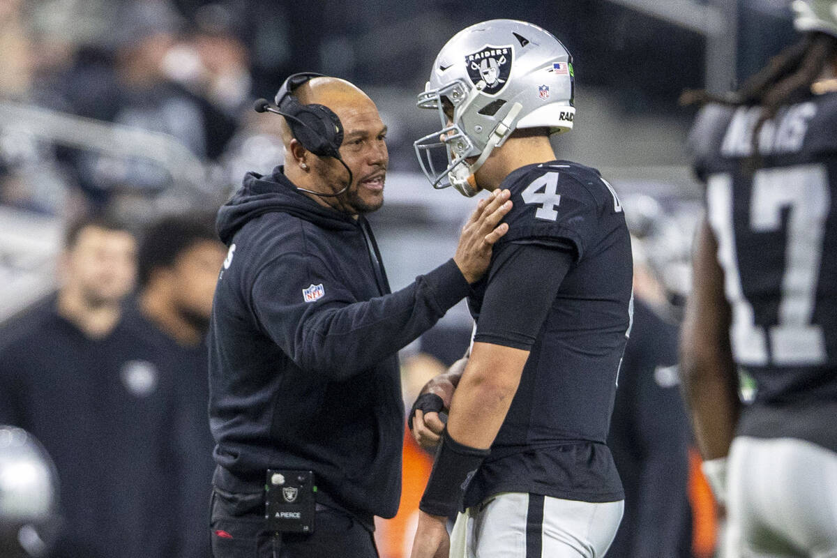 Raiders interim head coach speaks with quarterback Aidan O'Connell (4) during a time out during ...