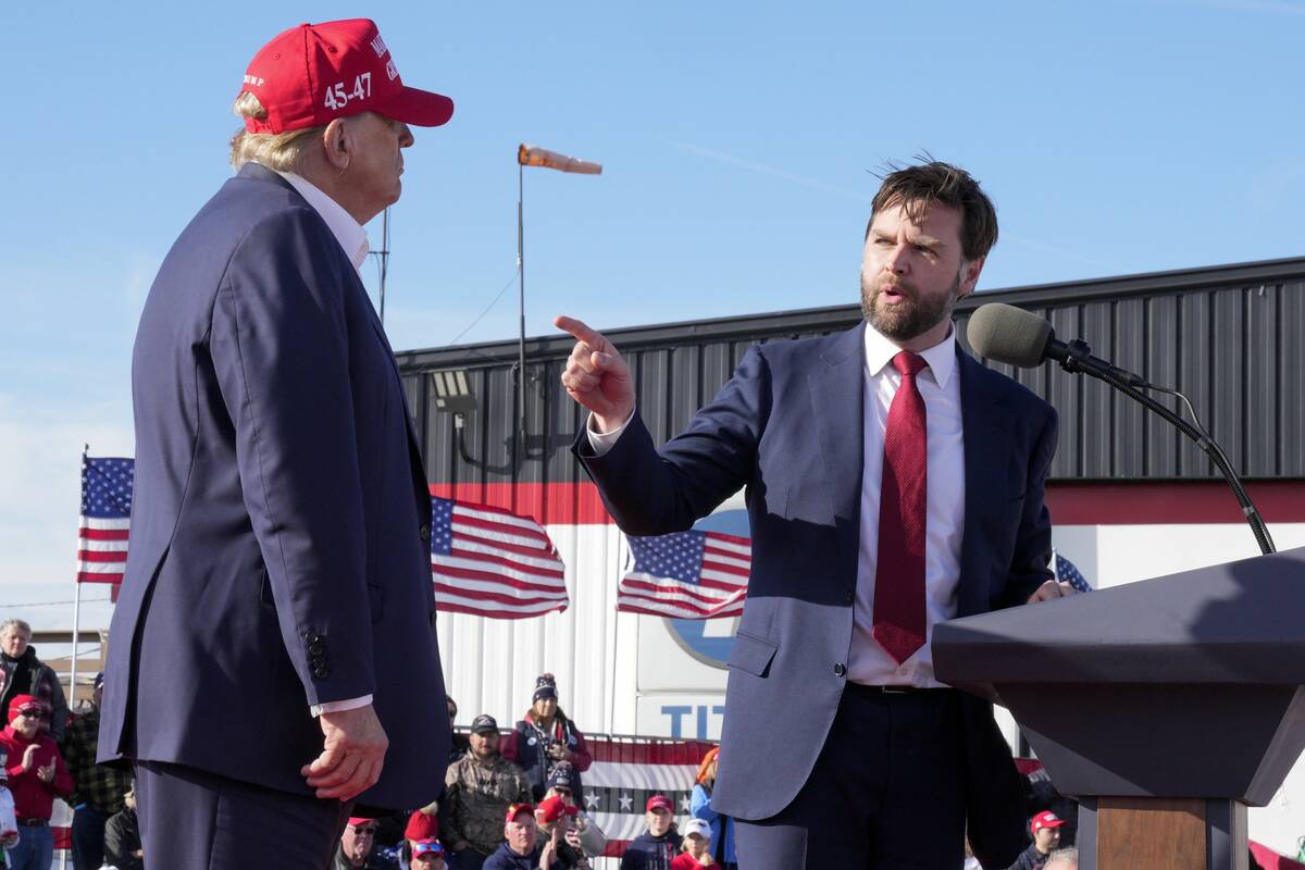 Sen. J.D. Vance, R-Ohio, right, points toward Republican presidential candidate former Presiden ...