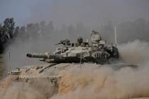 An Israeli tank maneuvers near the Israel-Gaza border in southern Israel, Friday, July 12, 2024 ...