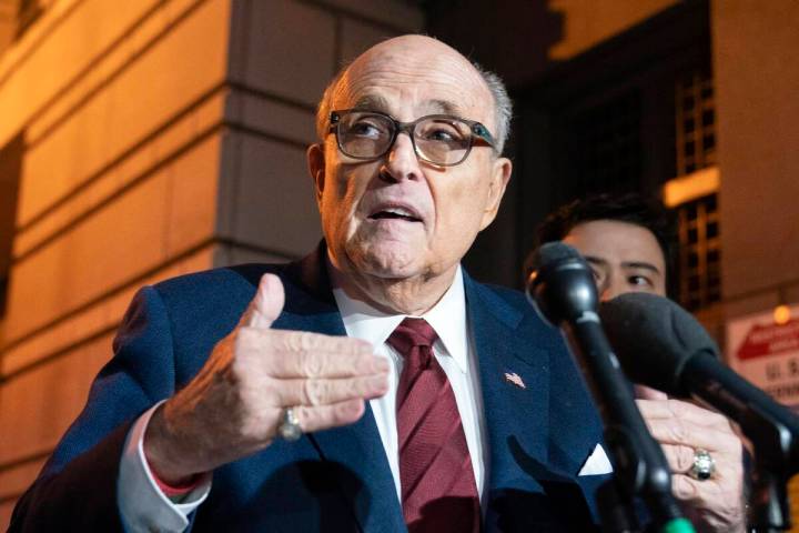 FILE - Former New York Mayor Rudy Giuliani talks to reporters as he leaves the federal courthou ...