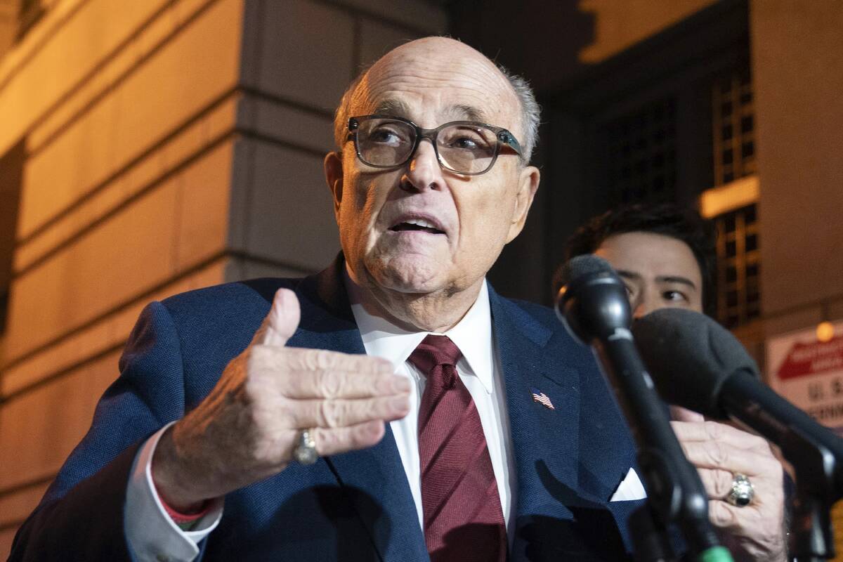 FILE - Former New York Mayor Rudy Giuliani talks to reporters as he leaves the federal courthou ...