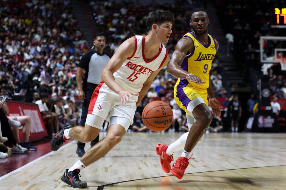 Houston Rockets guard Reed Sheppard (15) dribbles while Los Angeles Lakers guard Bronny James J ...