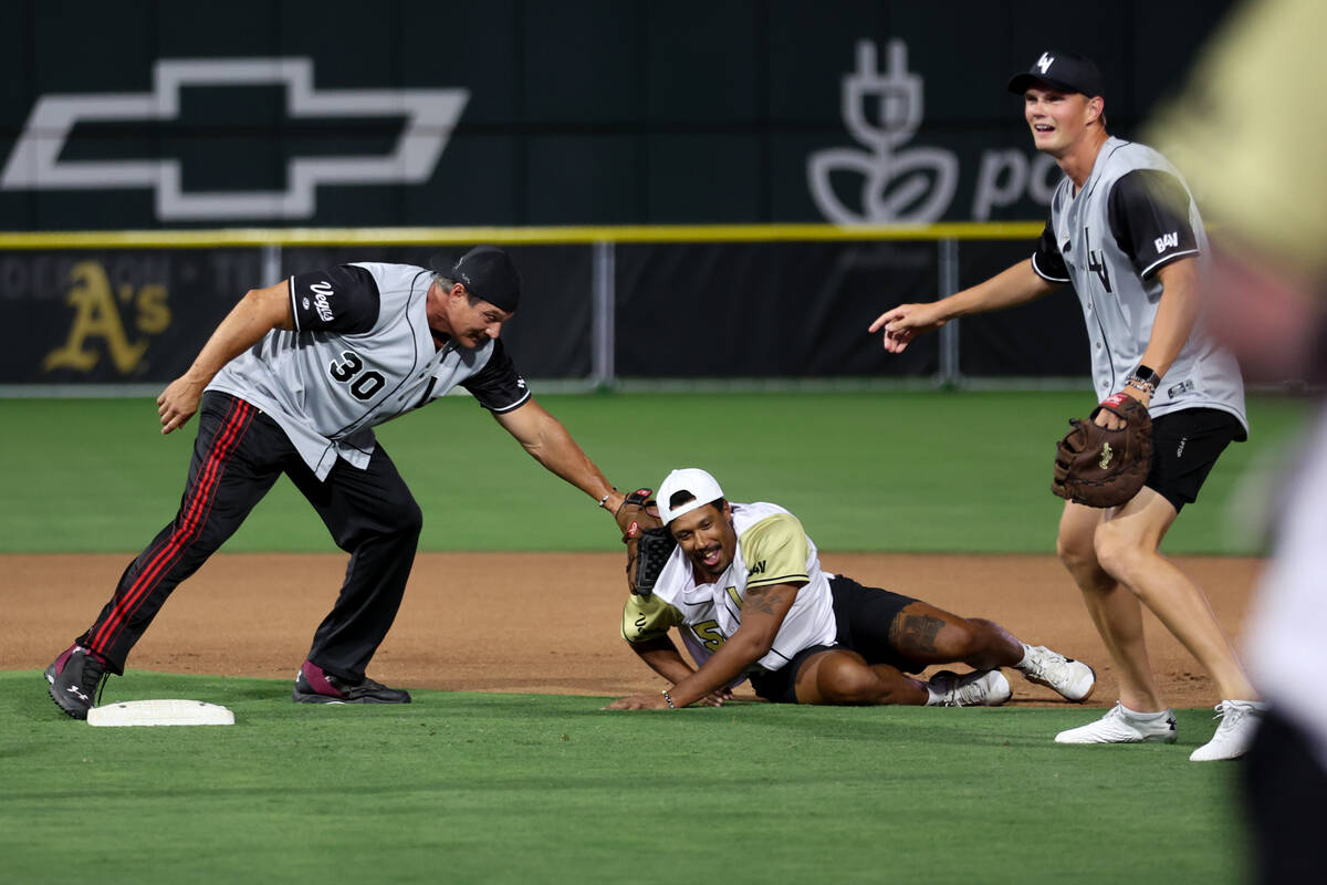 The Raiders’ Ozzie Canseco, a former MLB player tags out Golden Knights defenseman Keega ...