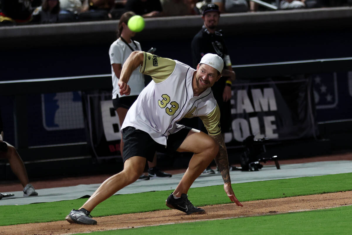 Golden Knights goaltender Adin Hill pivots to return to third base as the ball flies through th ...