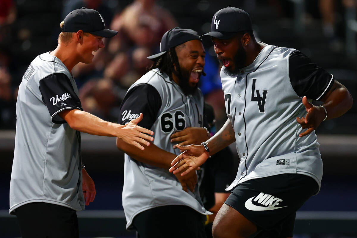 Raiders offensive tackle Thayer Munford Jr., right, is congratulated by kicker Daniel Carlson, ...