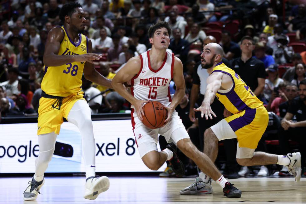 Houston Rockets guard Reed Sheppard (15) drives toward the hoop against the Los Angeles Lakers ...
