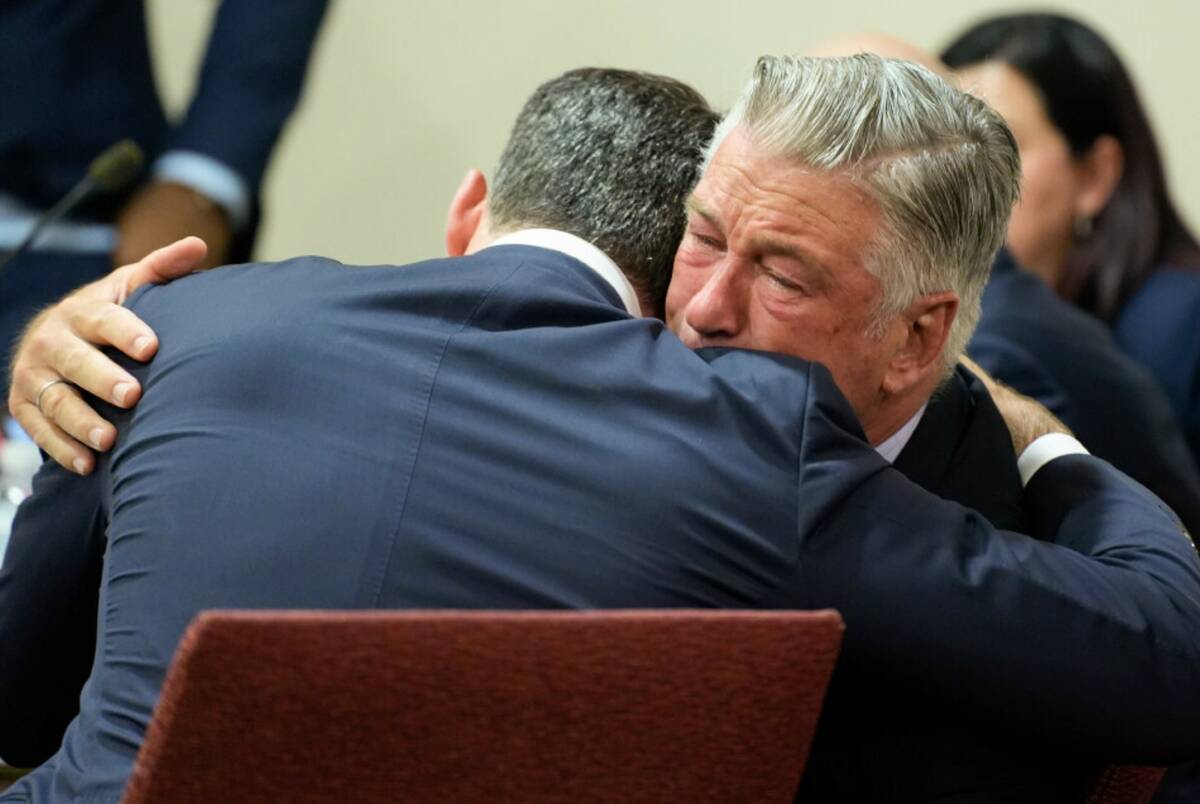 Actor Alec Baldwin, right, hugs his attorney Alex Spiro after the judge threw out the involunta ...