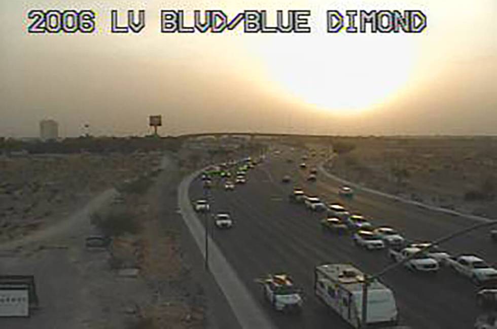 A setting sun is seen through a dusty sky from Las Vegas Boulevard South and Blue Diamond Road ...