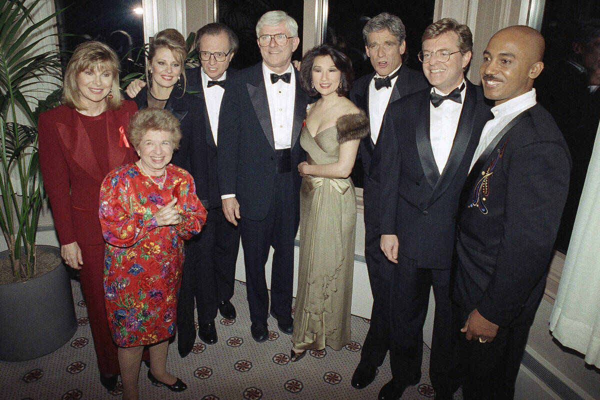 FILE - Talk show host Phil Donahue, center, poses with several other prominent television perso ...