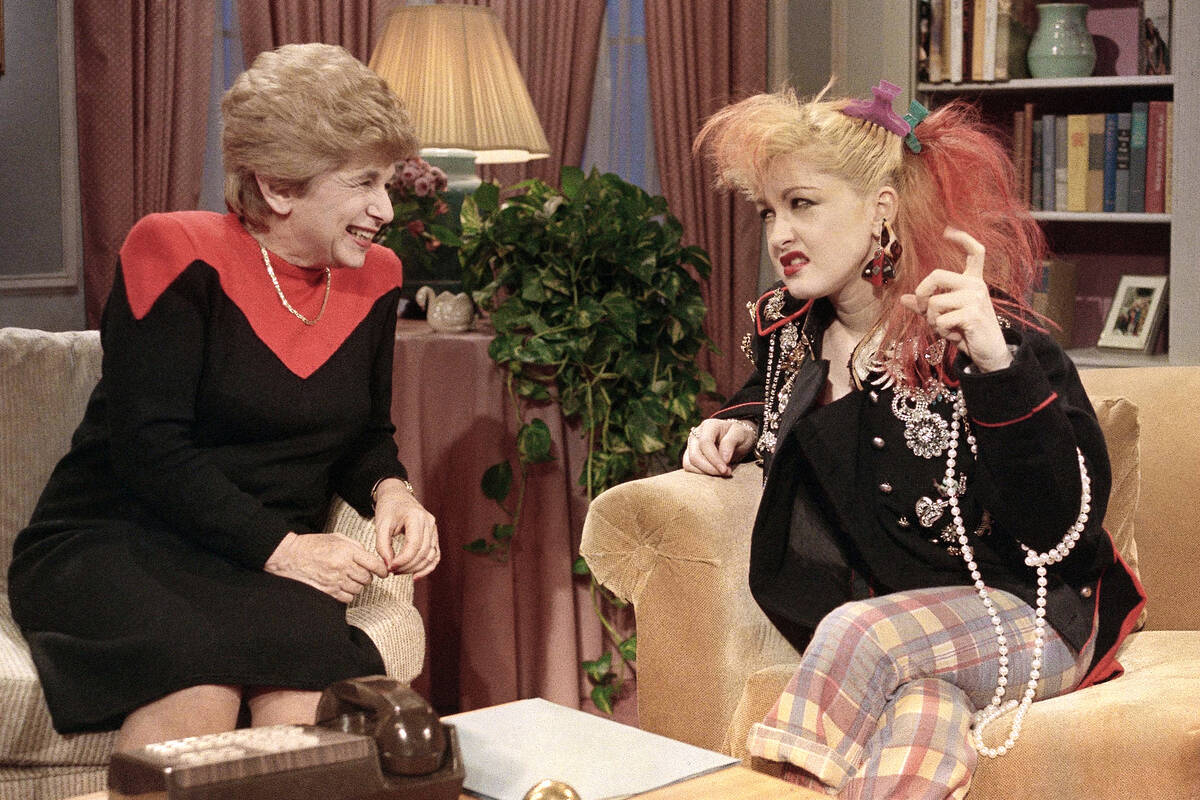FILE - Sex therapist Dr. Ruth Westheimer talks with rock singer Cyndi Lauper in New York, Jan. ...