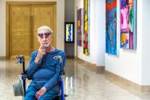 Dr. Robert Belliveau among his wife's works on display at the Rita Deanin Abbey Art Museum on T ...