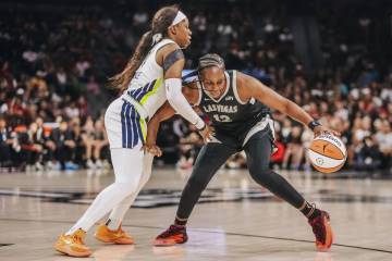 Aces guard Chelsea Gray (12) works against Dallas Wings guard Arike Ogunbowale (24) with the ba ...