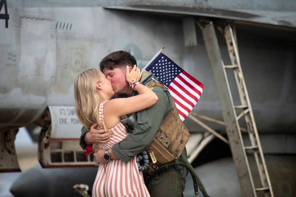 Lindsay Nelson kisses her husband, Robert "Fat Goose" Nelson, after he returned to NA ...