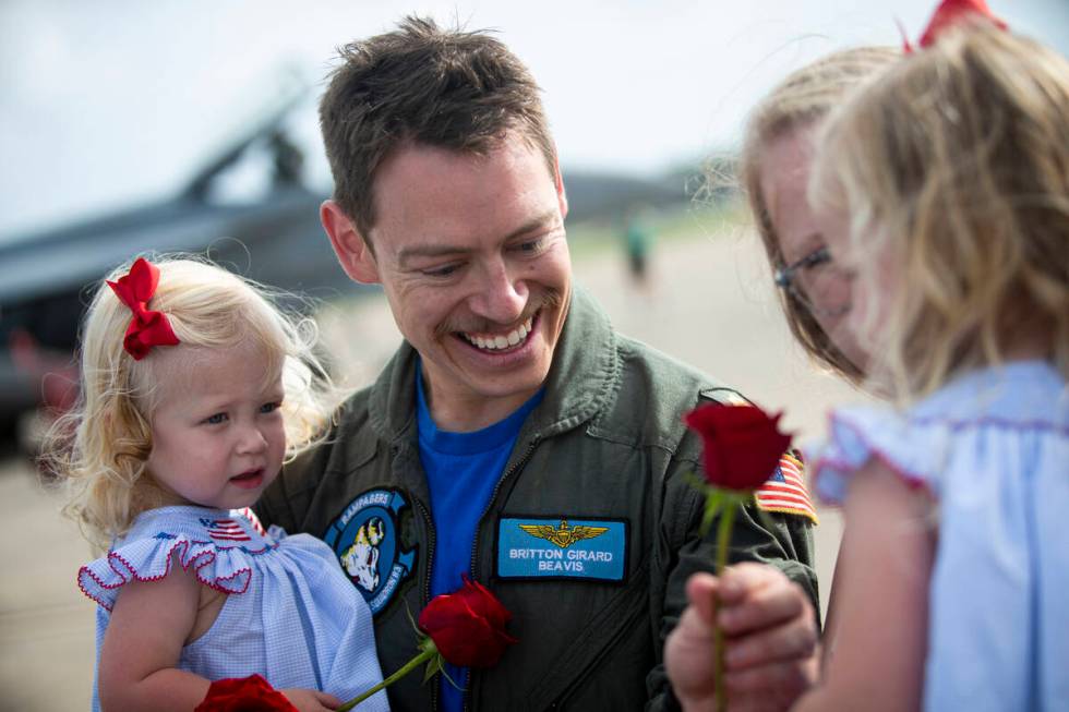 Britton "Beavis" Girard of Strike Fighter Squadron 83 presents a rose to his daughter ...