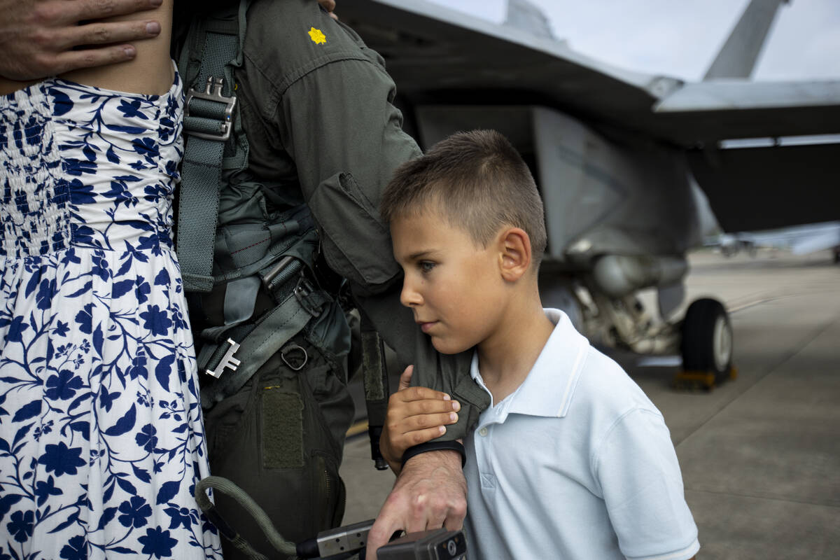 Jacob Jeronimus, 8, holds on to his father's arm after members of Carrier Air Wing (CVW) 3 retu ...