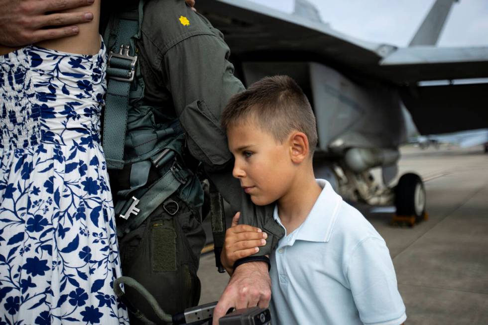 Jacob Jeronimus, 8, holds on to his father's arm after members of Carrier Air Wing (CVW) 3 retu ...