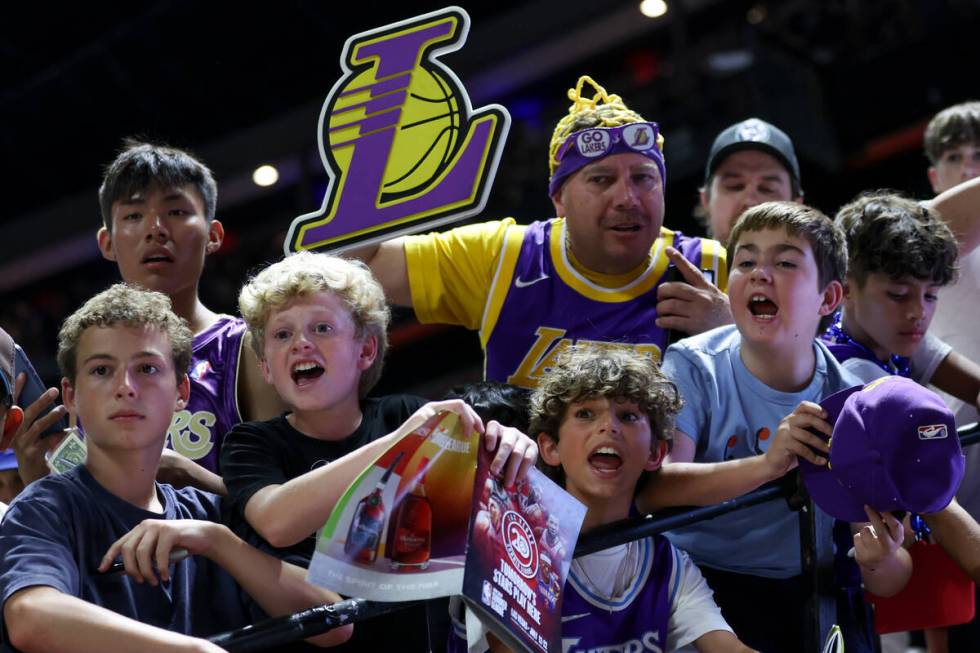Fans shout for autographs as the Los Angeles Lakers leave the court after they lost an NBA summ ...