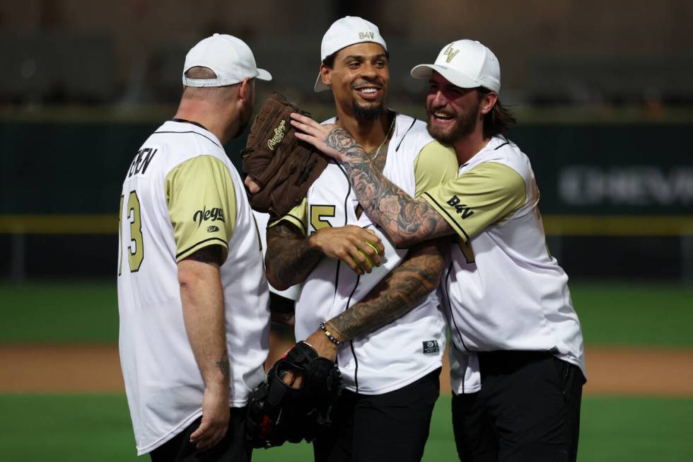 Former Golden Knights Ryan Reaves, center, and Logan Thompson, celebrate as they win the annual ...