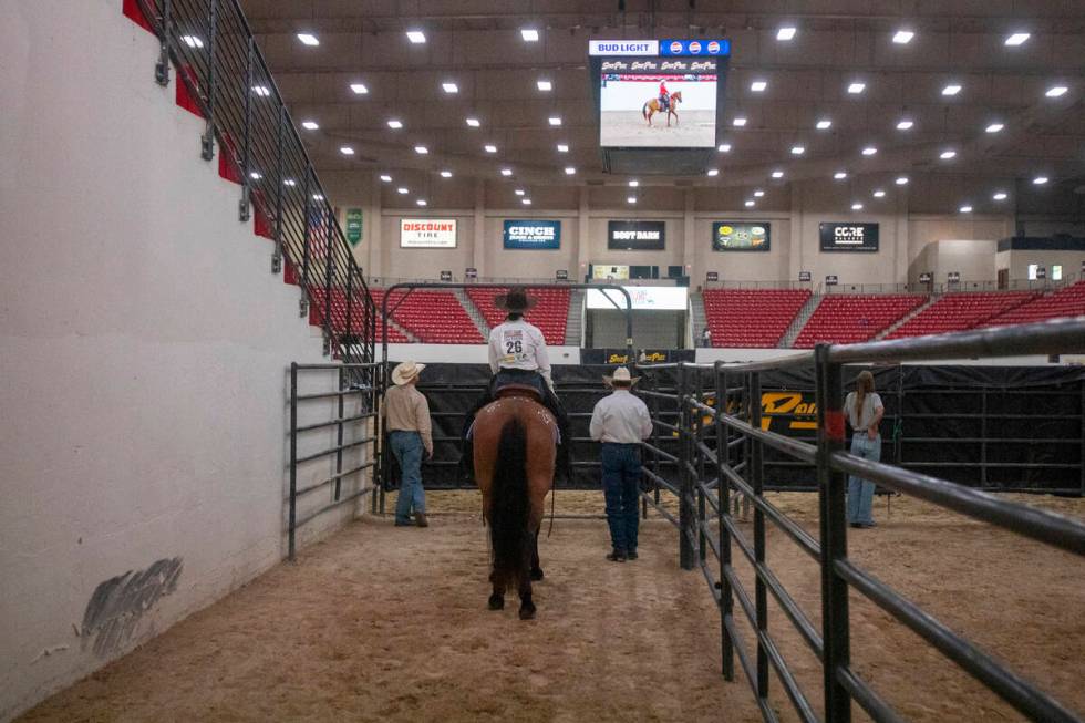 Competitors wait in a chute before competing in the Mustang Challenge at South Point Arena, Fri ...