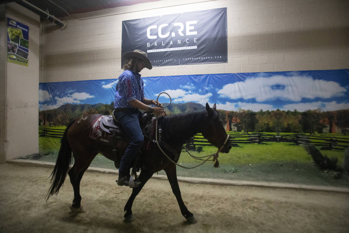 Isaac Kent, of Brandon, Minnesota, takes his mustang to the warm-up area during the Mustang Cha ...
