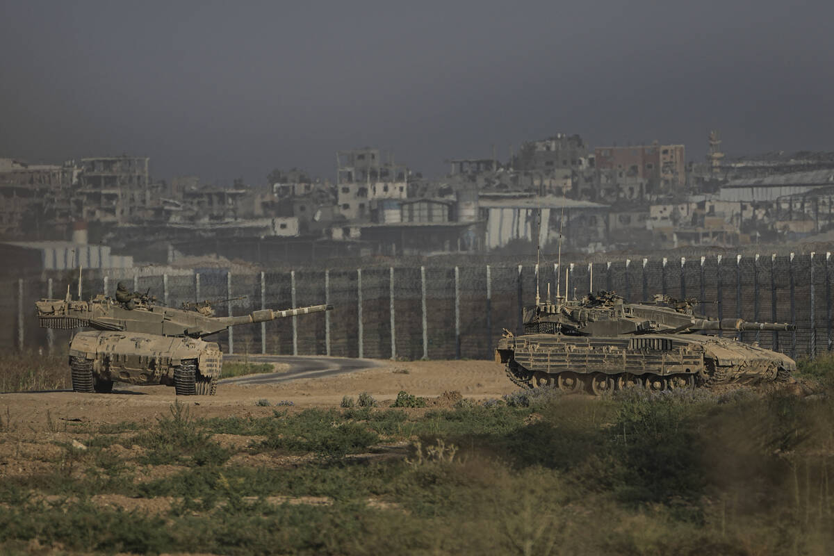 Israeli tanks stand near the Israel-Gaza border as seen from southern Israel Sunday, July 14, 2 ...