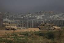 Israeli tanks stand near the Israel-Gaza border as seen from southern Israel Sunday, July 14, 2 ...