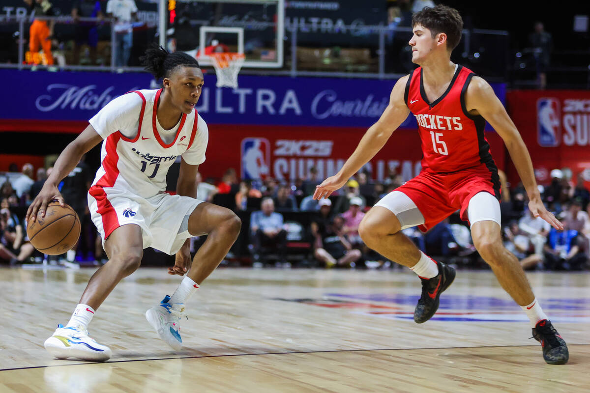 Washington Wizards guard Bub Carrington (17) dribbles the ball as Houston Rockets guard Reed Sh ...
