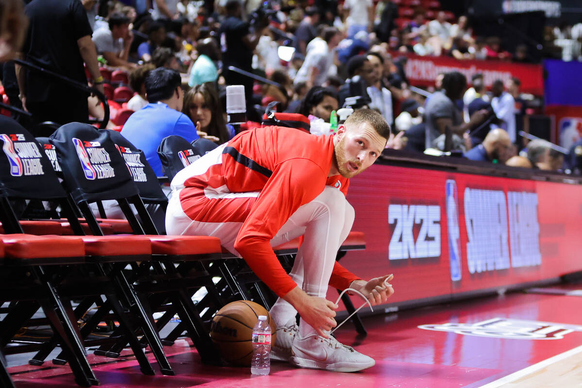 Atlanta Hawks forward Dylan Windler ties his shoe during halftime at an NBA Summer League game ...