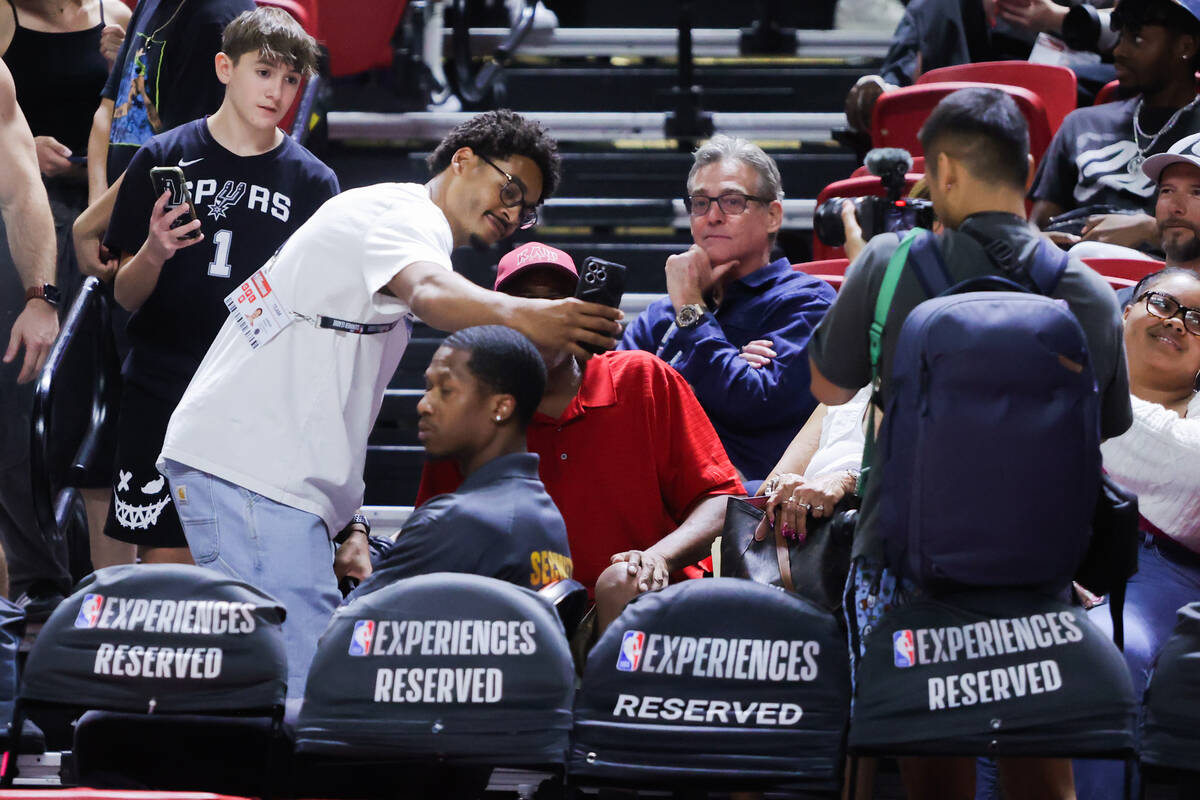 Washington Wizards shooting guard Jordan Poole stops to take photos with fans during an NBA Sum ...