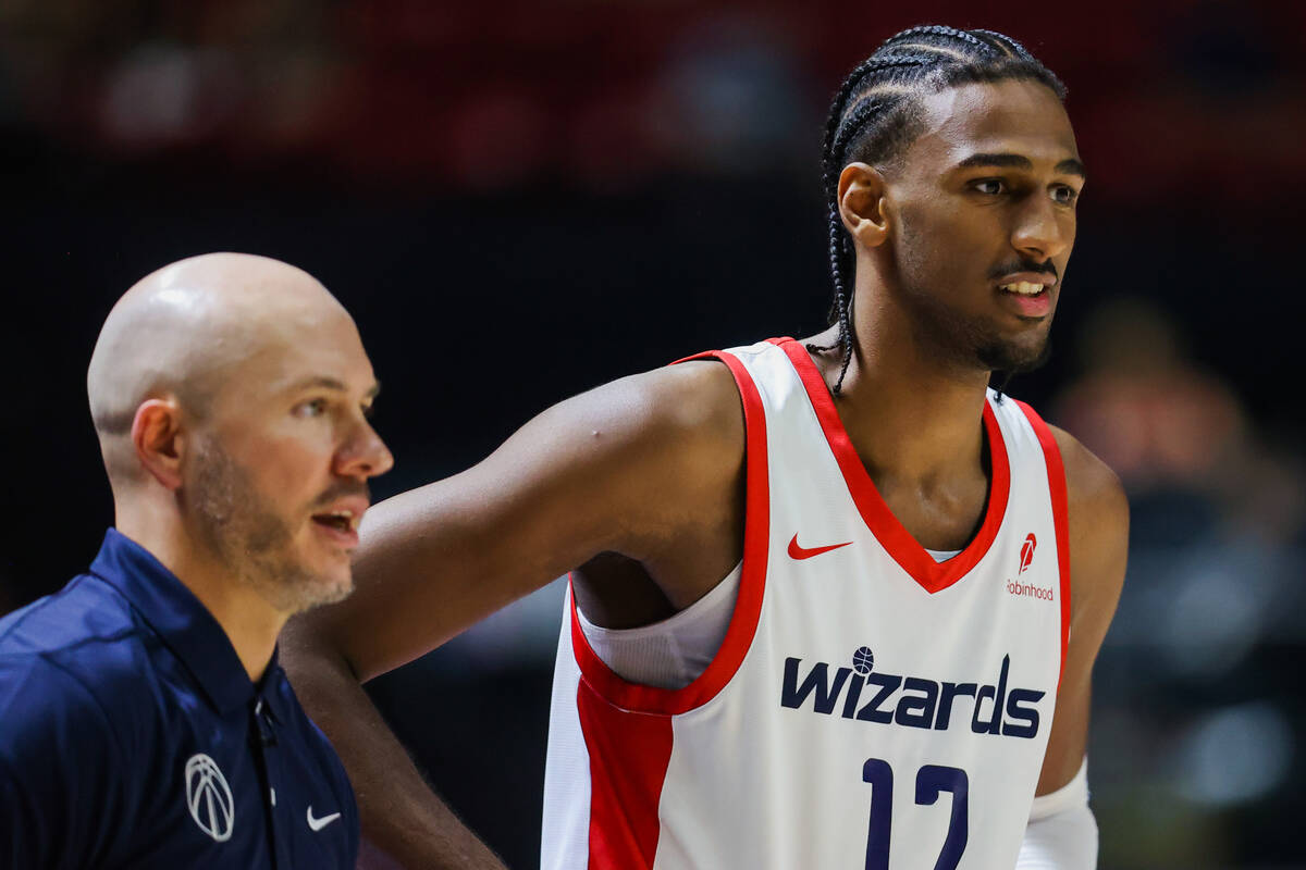 Washington Wizards center Alex Sarr (12) speaks to his coach during an NBA Summer League game b ...