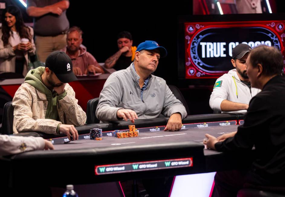 Jason Sagle, of Canada, center, plays in the final two tables of the World Series of Poker Main ...