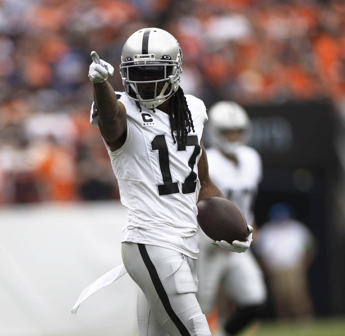 Raiders wide receiver Davante Adams (17) points to signal for a first down during the first hal ...