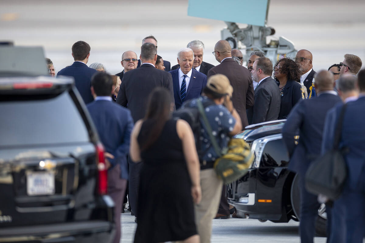 President Joe Biden talks to a group of people after exiting Air Force One at Harry Reid Intern ...