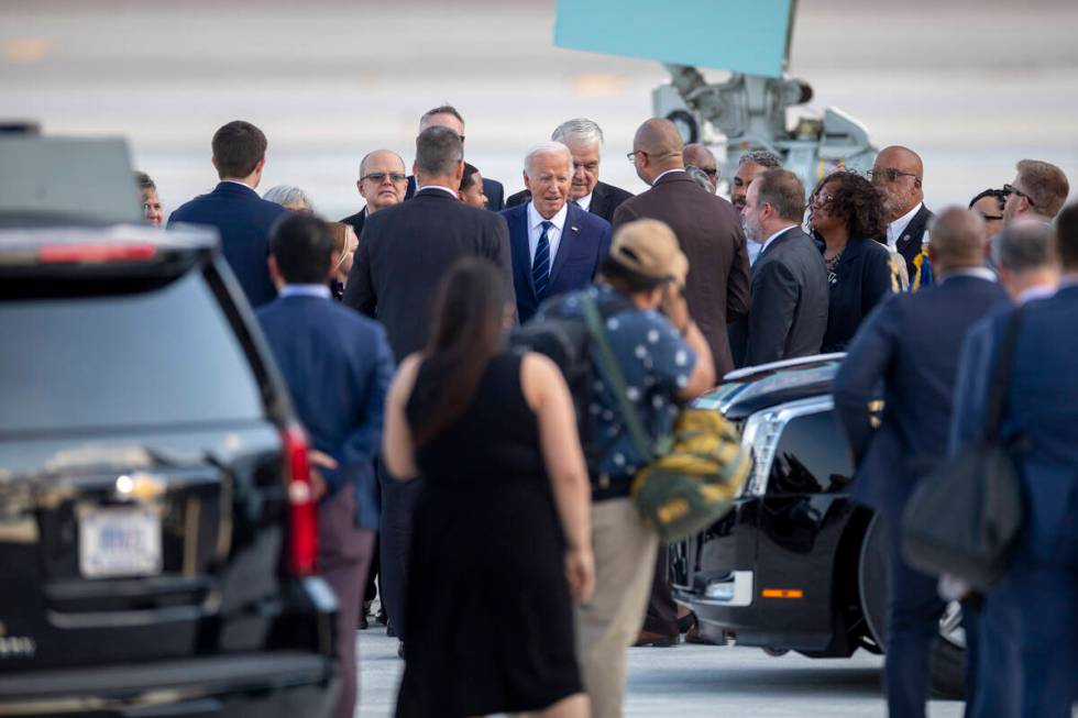 President Joe Biden talks to a group of people after exiting Air Force One at Harry Reid Intern ...